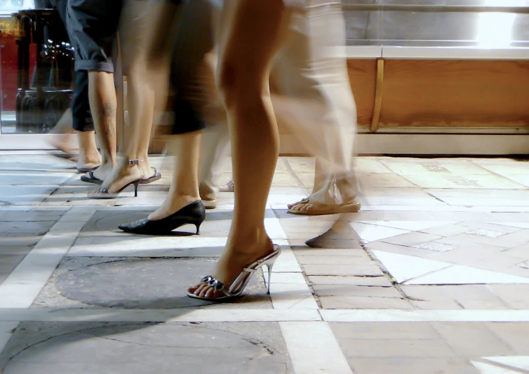 a close up of two pairs of people in heels