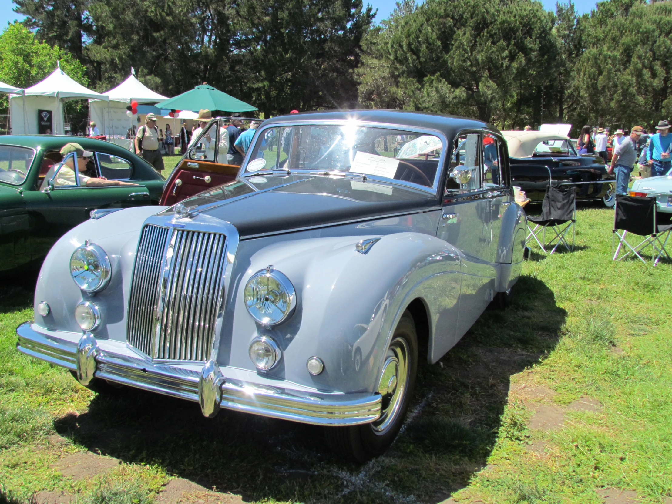 many classic cars are parked outside by themselves