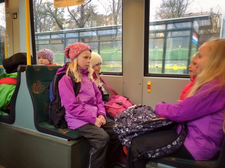 two woman and a child are sitting on a subway