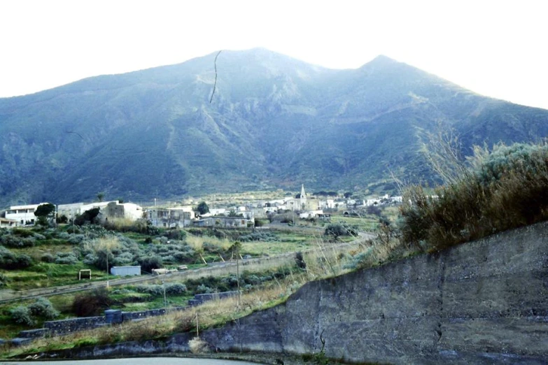 a road leading towards mountains in a rural area