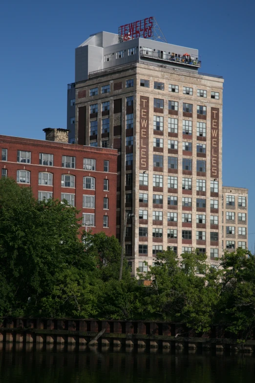 a high rise building and some trees in front