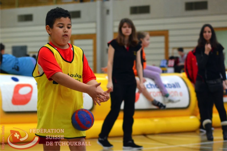 three s playing basketball in a gymnasium