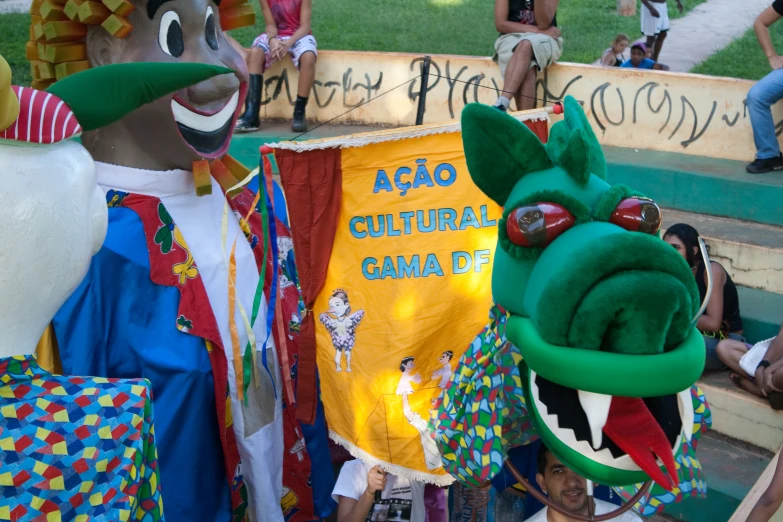 a group of people standing around with colorful animal costumes