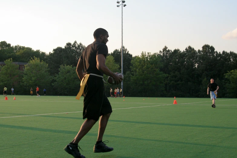 a man holding a frisbee on a field