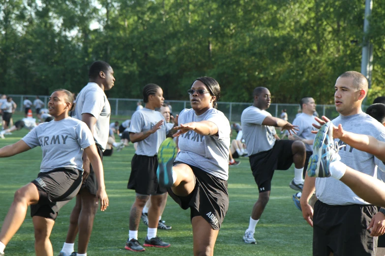 several people with white shirts and black shorts playing frisbee