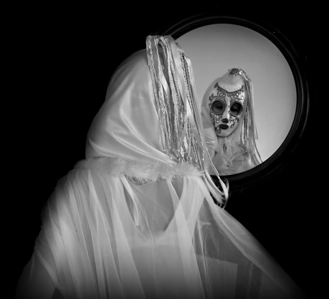 a woman with makeup and a skeleton face behind a mirror