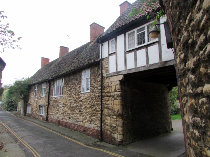 a brown building with two stories with a long door