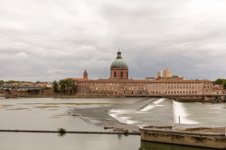 large body of water that runs into a city with large buildings on both sides