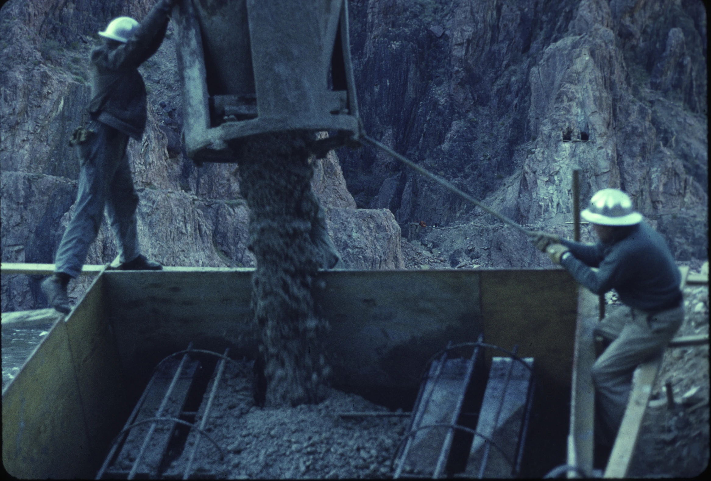 two men working on the rock quarry in the evening