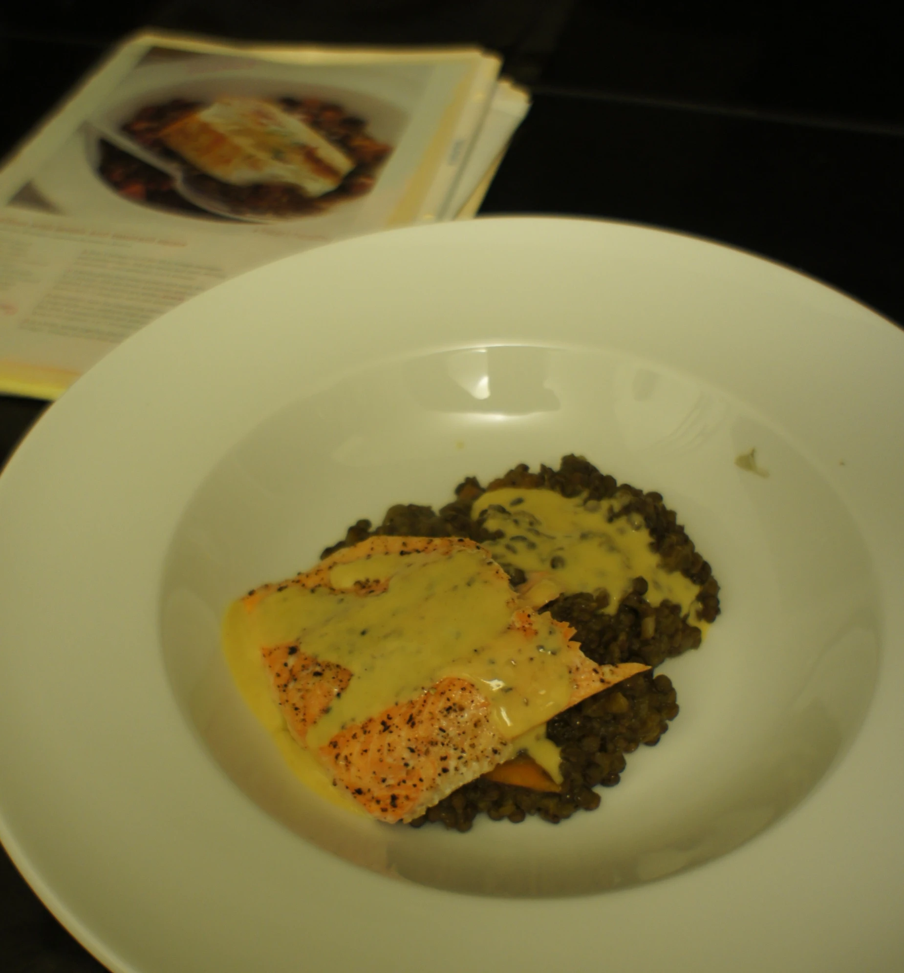 a bowl of food and a book are on the table