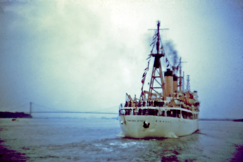 an old ship floating on top of the ocean