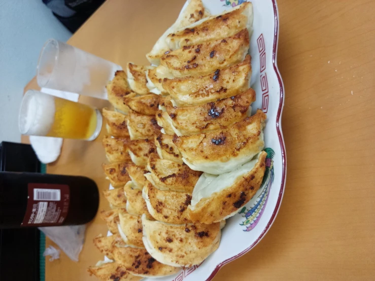 a white plate topped with pancakes next to drinks