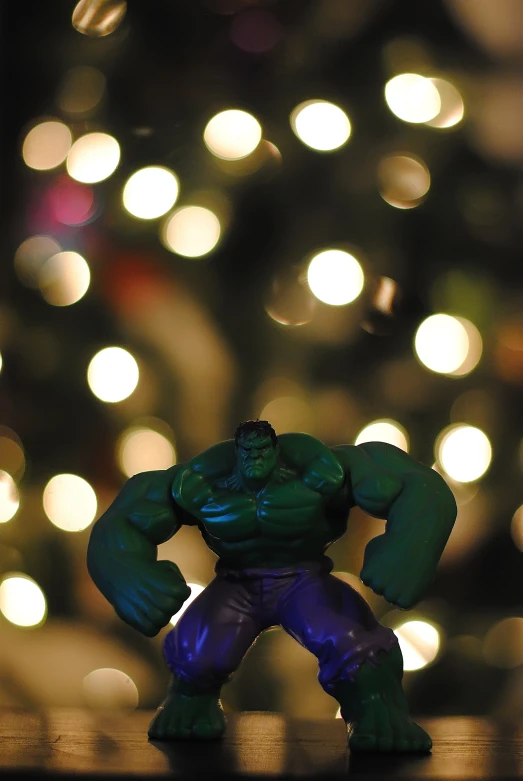 a close up of a toy hulk in front of a christmas tree