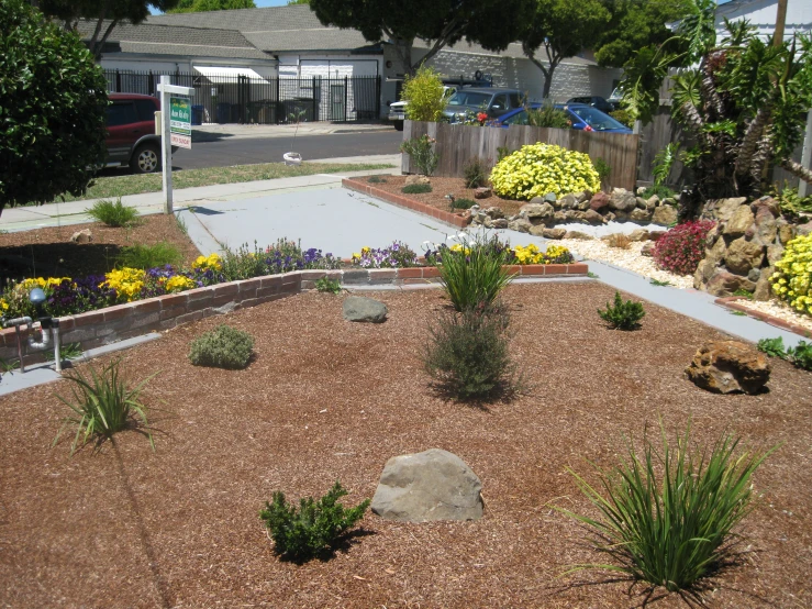 a yard with some flowers and landscaping around it