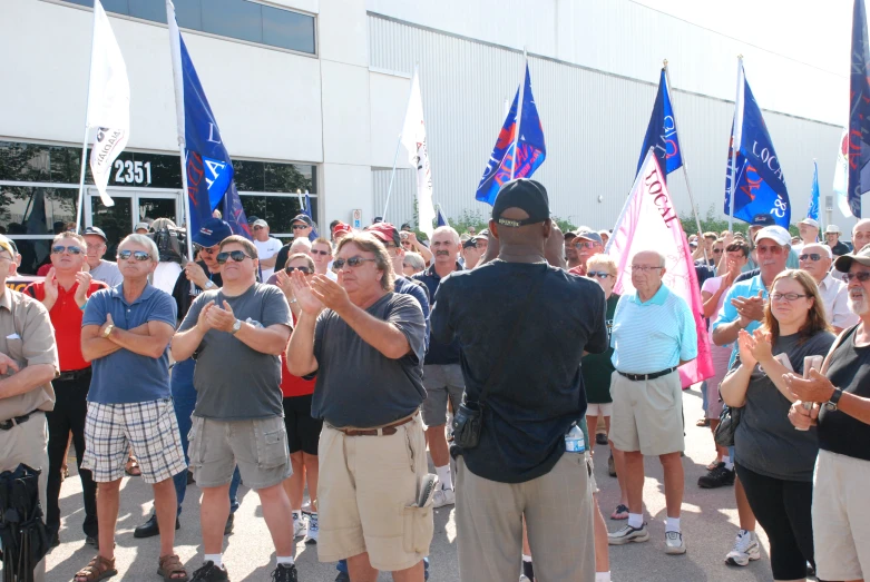 a man is giving a crowd a victory with his hands