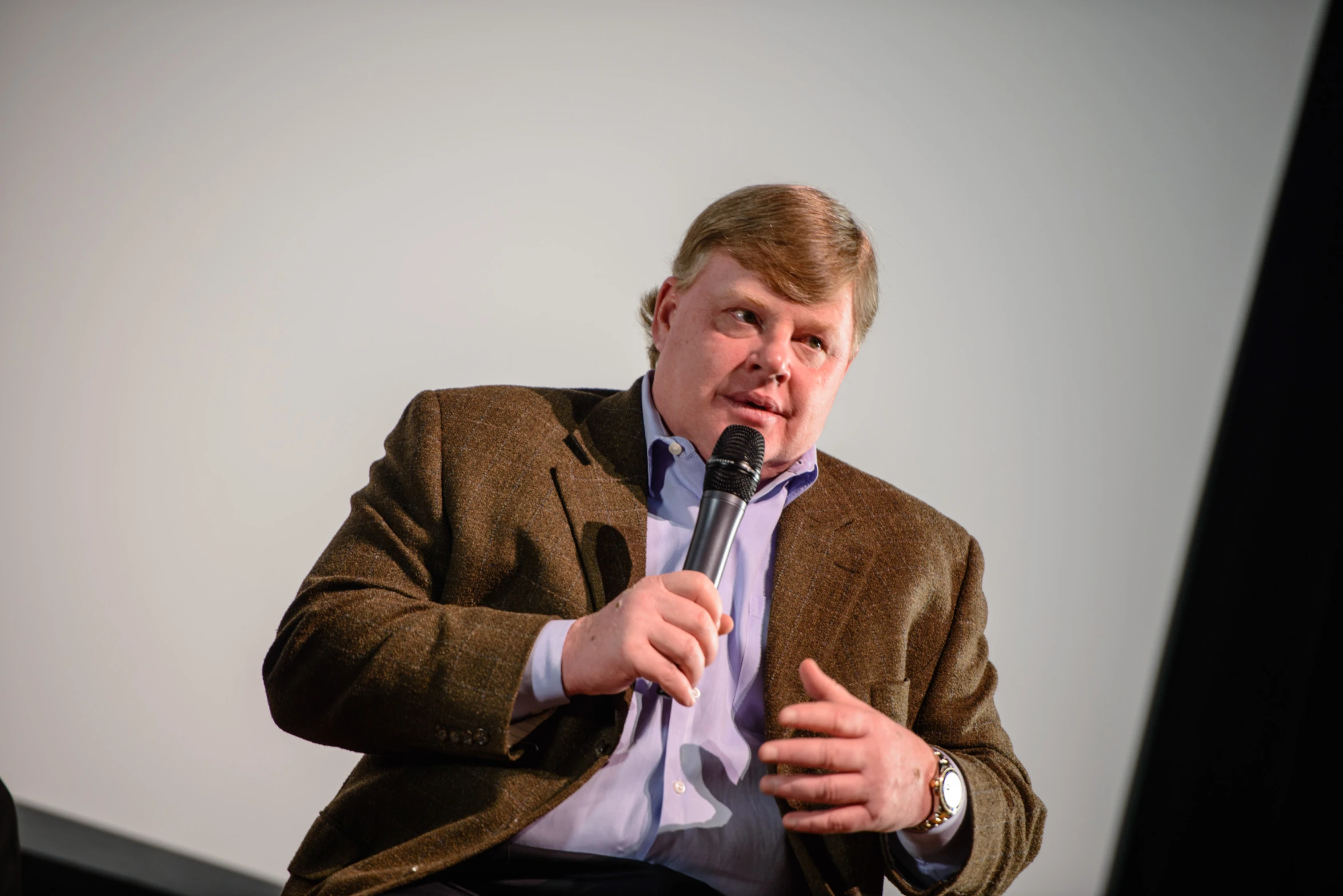 a man with a microphone in his hands