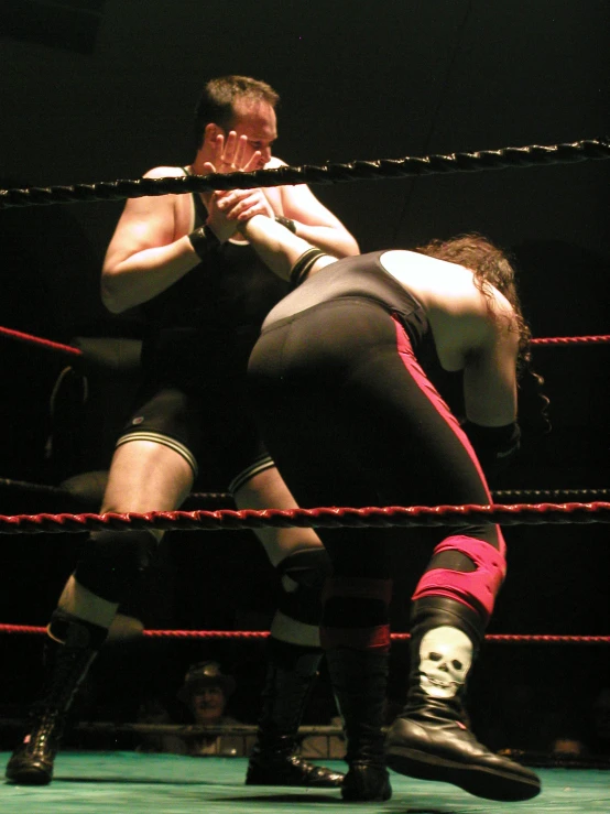 two men wrestling in the ring together