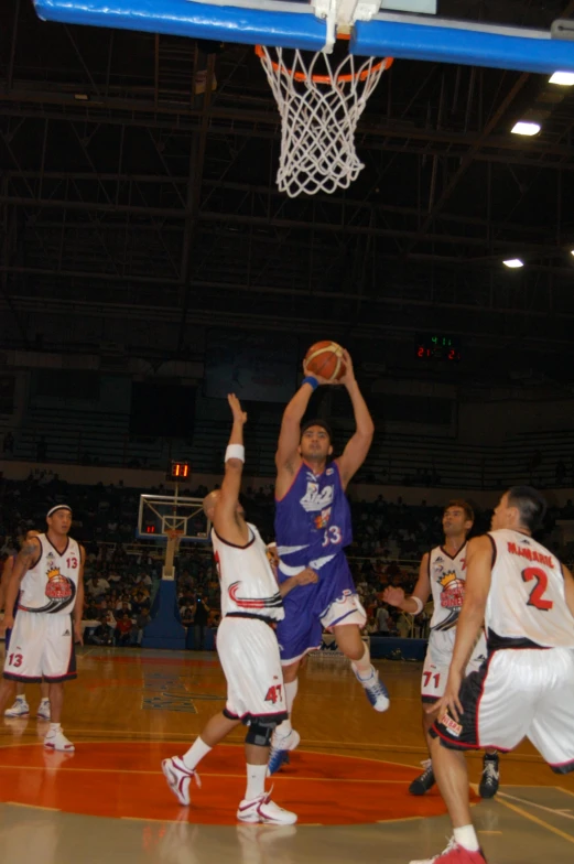 a group of men on a court playing basketball