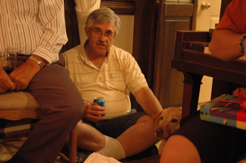 a man in a white shirt is sitting and people