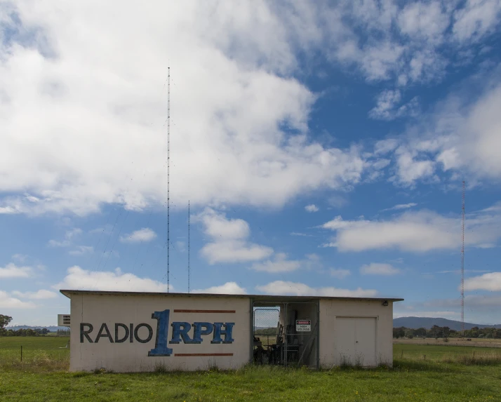 an old radio and radio tower with a blue sky