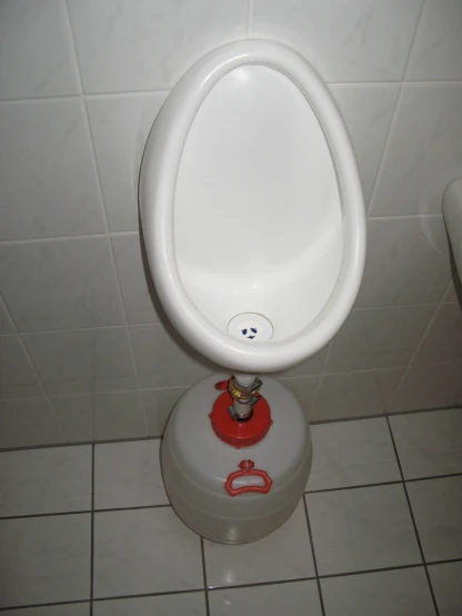 this is a urinal that looks like it has a water bottle on it