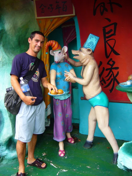 a fake rat and man holding a bag with the statue