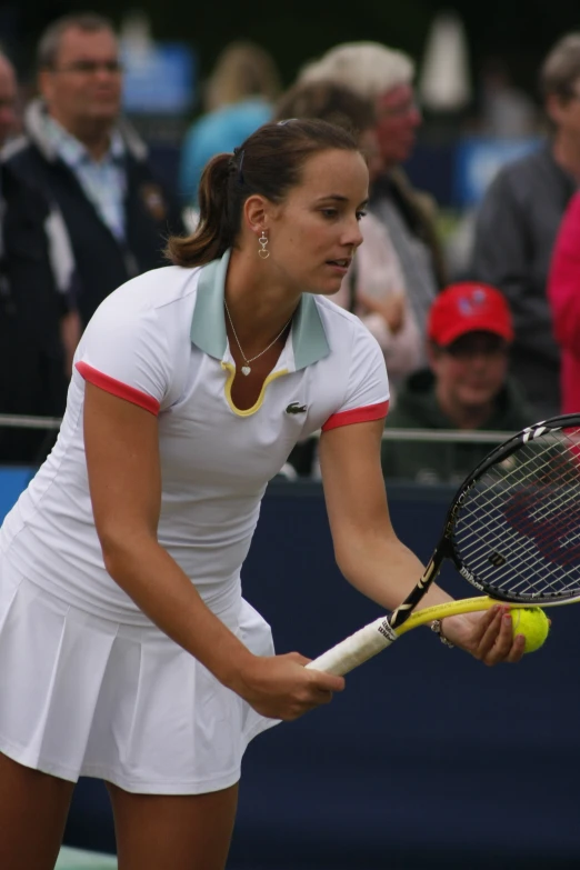 the female tennis player is hitting a ball