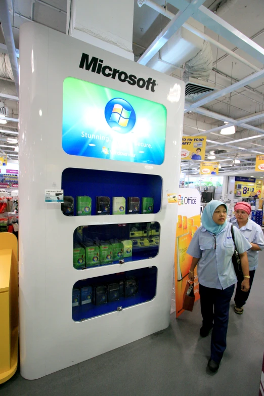 the customer is standing at the display for their computers