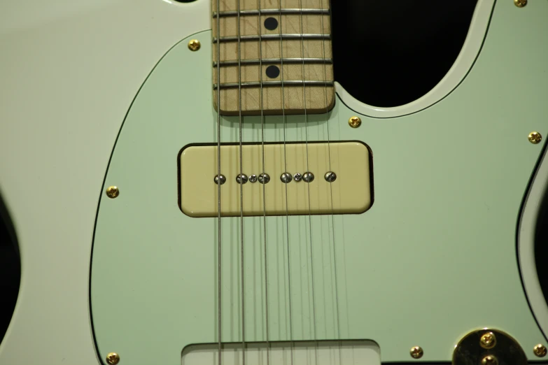 this is an image of the back of a light green guitar