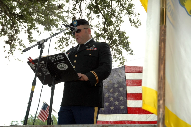 a marine stands at the front of a microphone