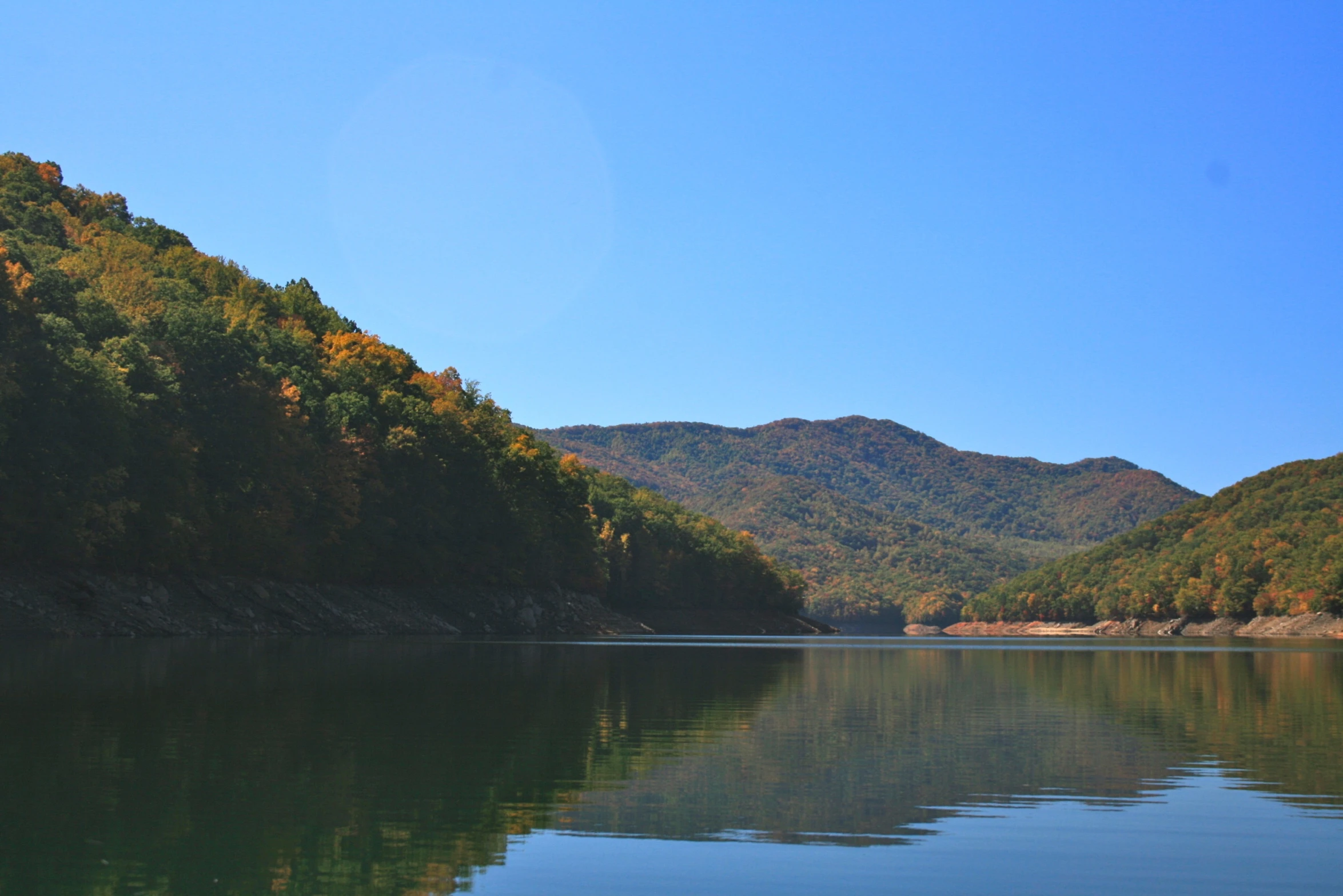 a mountain is reflected in the still water of a lake