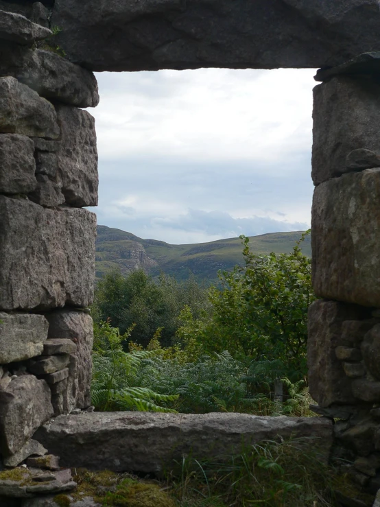 there is a picture through a window of stone