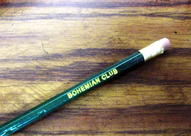 a green pen sits on a table top