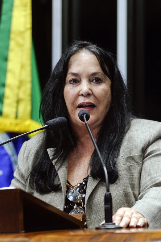 a woman giving a speech at a podium