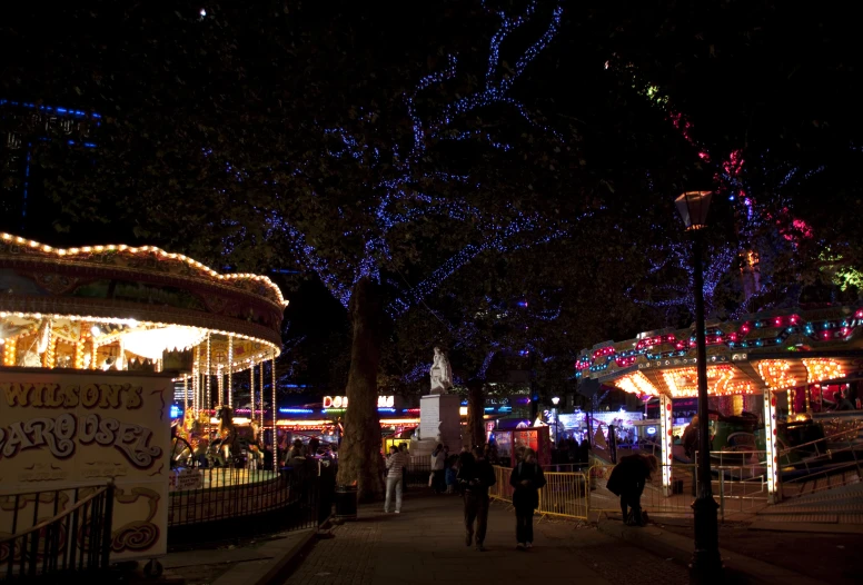 lights decorate the carousels in the night time