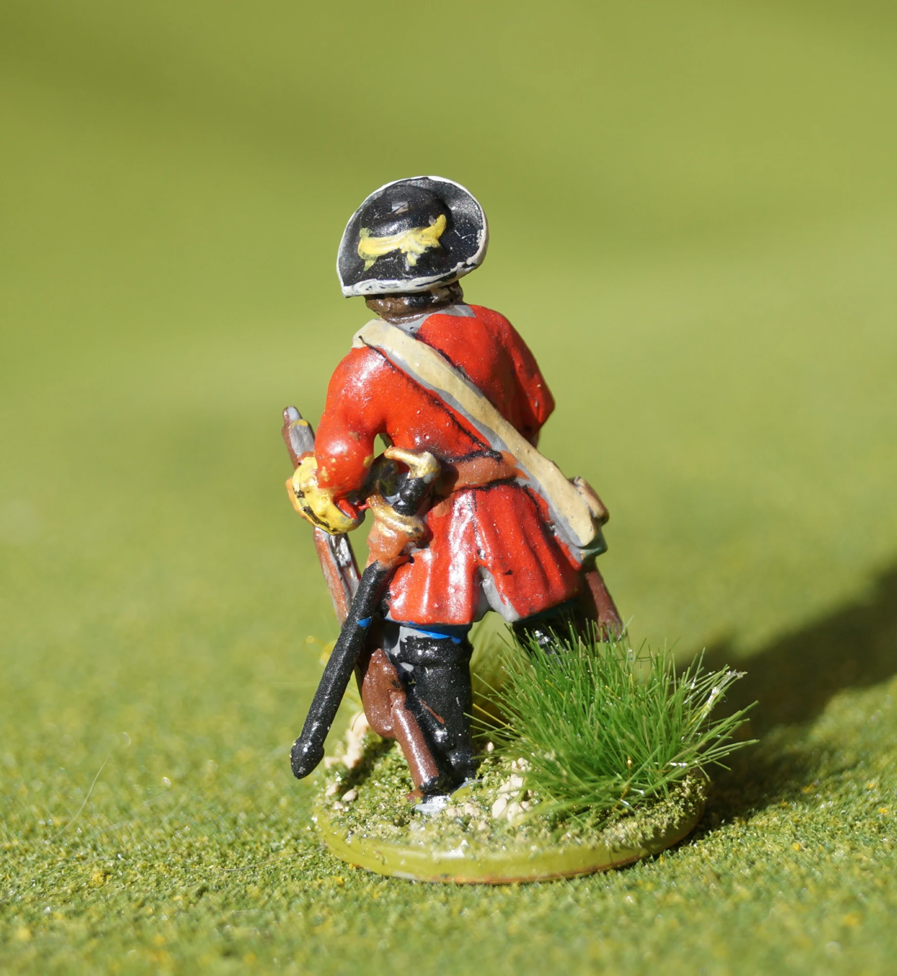 a toy soldier is holding a rifle