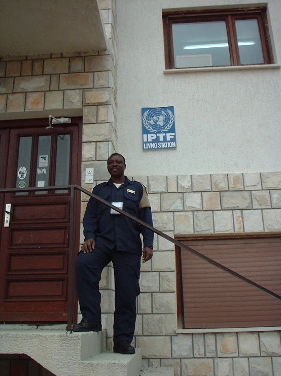 a police officer is standing on steps outside