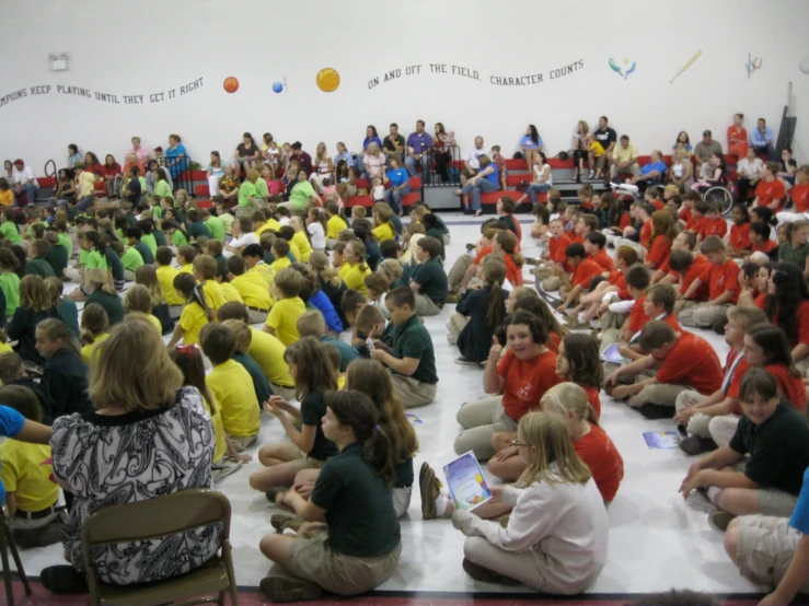 an audience is watching as a person reads a book