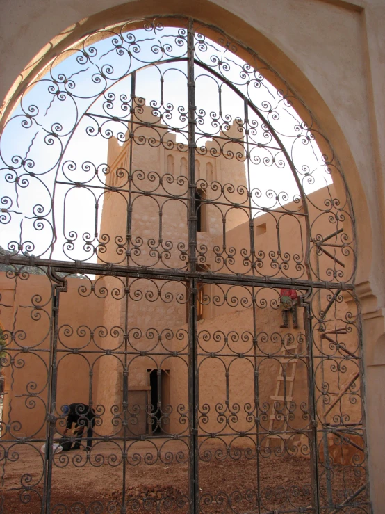 a large window sitting above a gate into a building