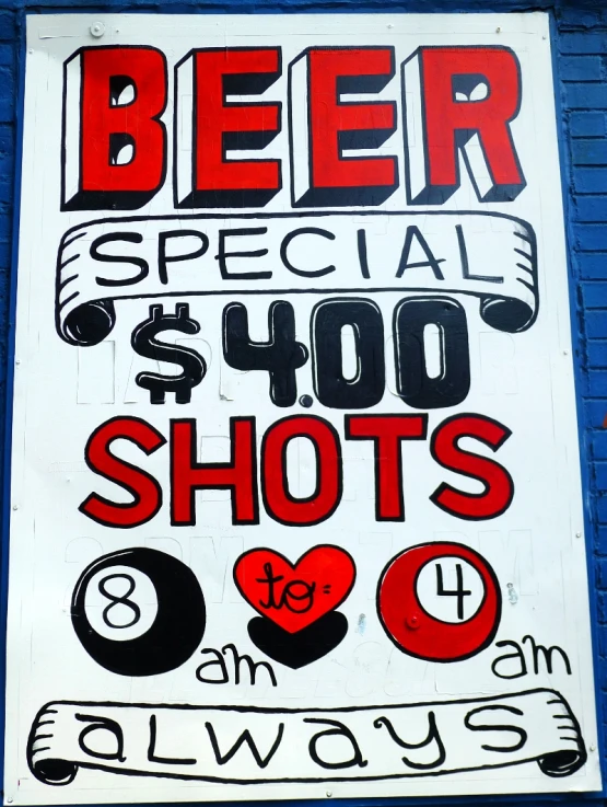 a sign in front of a blue brick wall advertising the beer specials