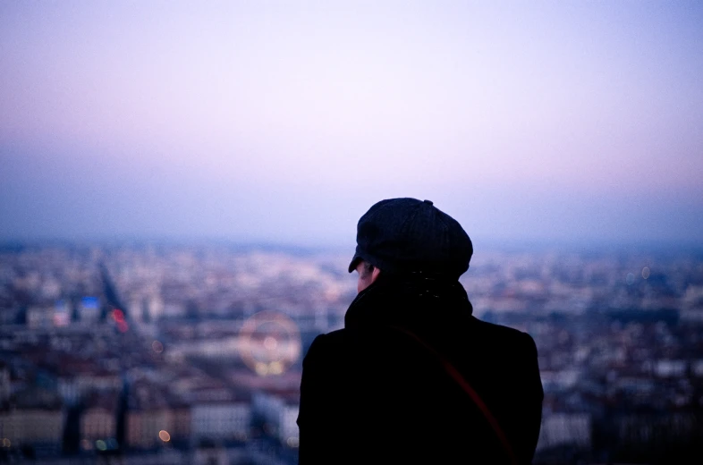 a woman standing in front of the view of the city