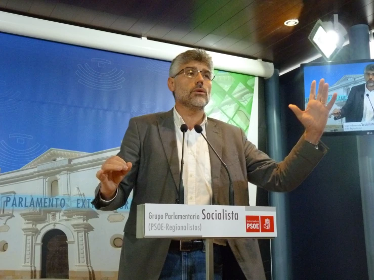 a man speaking to a crowd at a public event