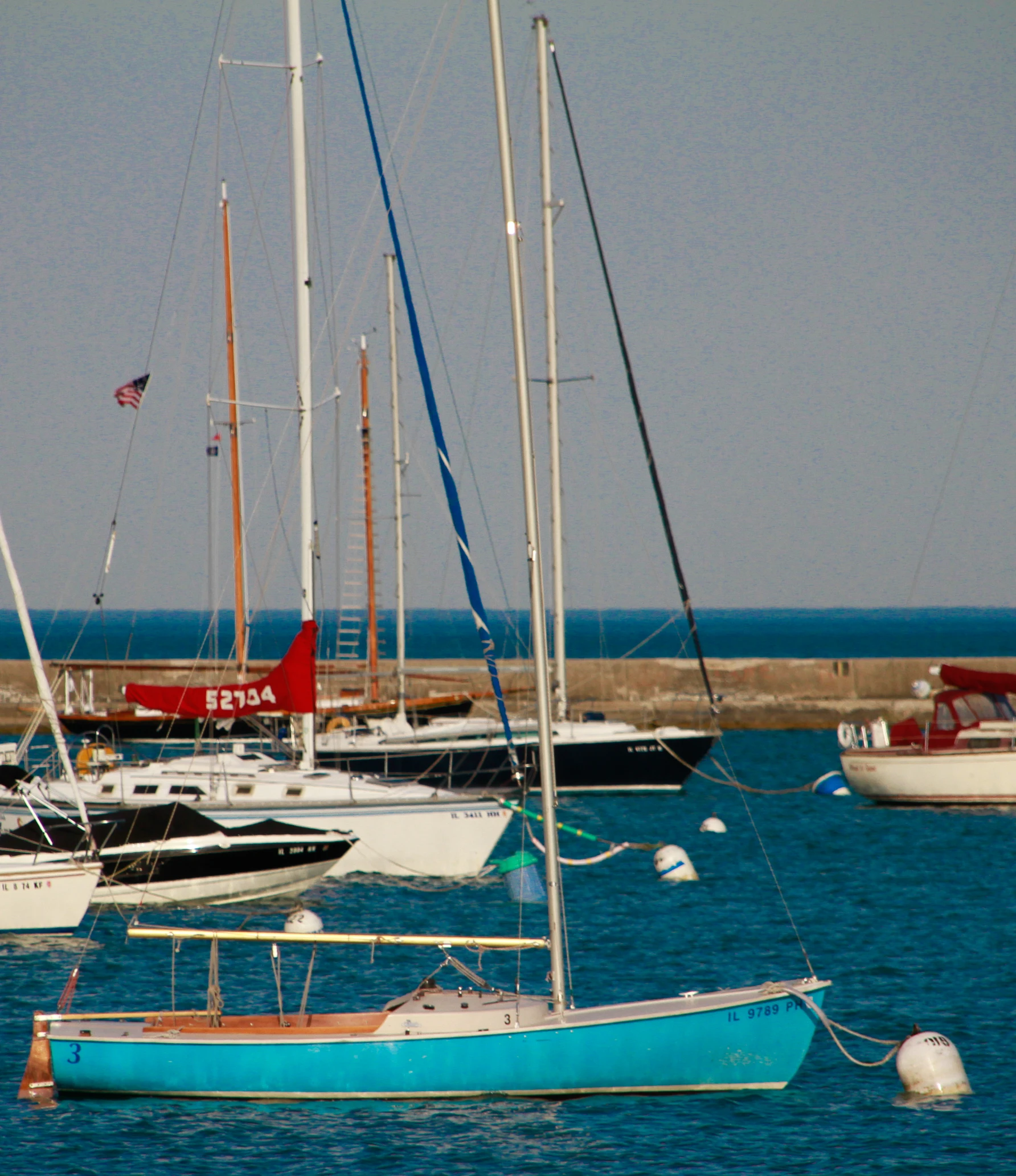 there are many sailboats docked on the water