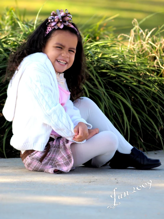 a little girl is smiling in the street