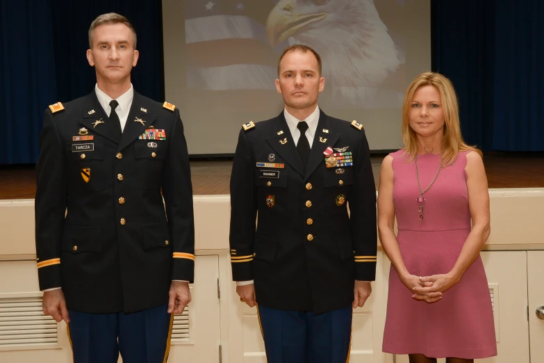 a man and two women in dress clothes are standing next to each other