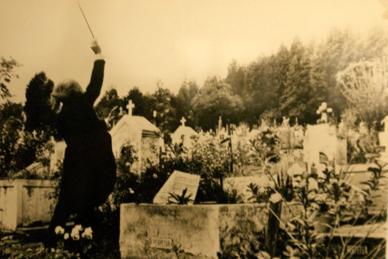 a man standing on top of a graveyard