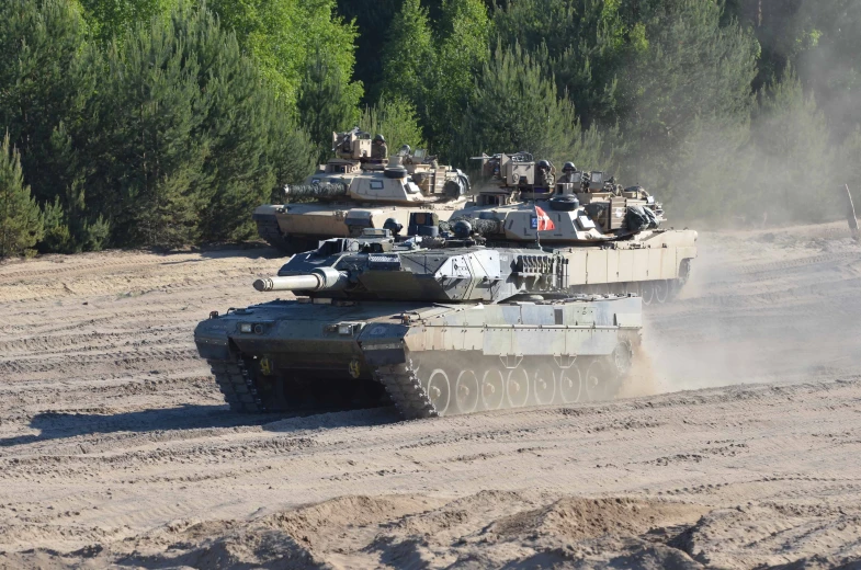 a group of tanks that are sitting in the dirt