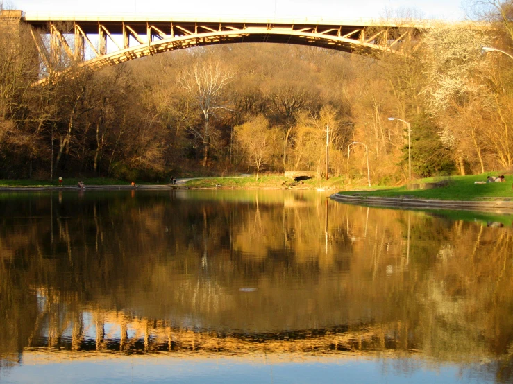 a scenic view of water with a bridge overhead