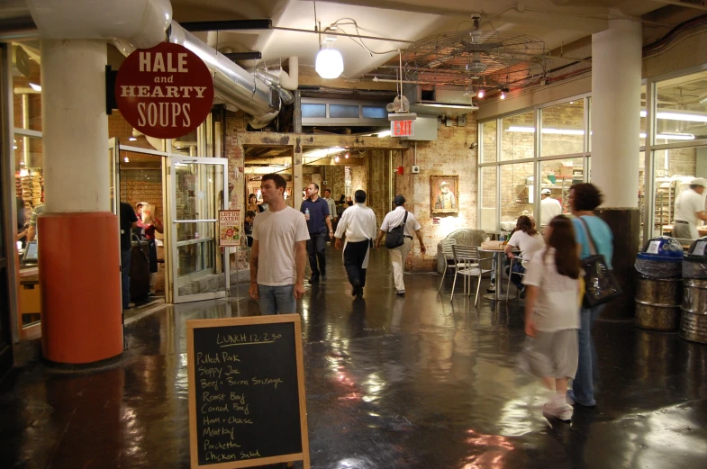 a group of people walk through a store