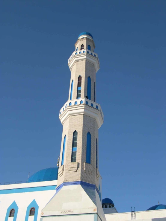 a very tall white clock tower towering over a city